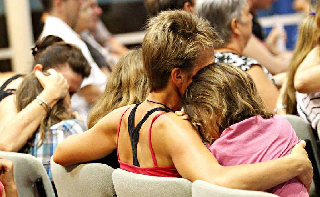 Mums comfort their children as friends and family of the Golinskis gather at The Anglican Church of Noosa yesterday. Mums comfort their children as friends and family of the Golinskis gather at The Anglican Church of Noosa yesterday.